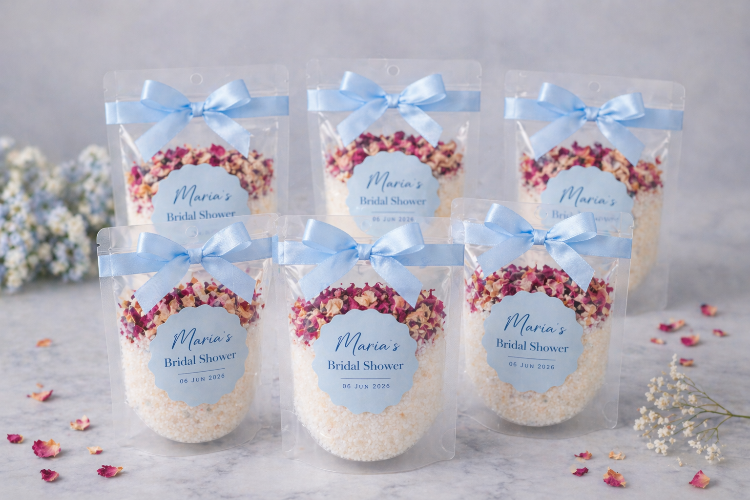 Custom bath soaks for Bridal Shower bath salts with floral designs and blue ribbons on a light background.