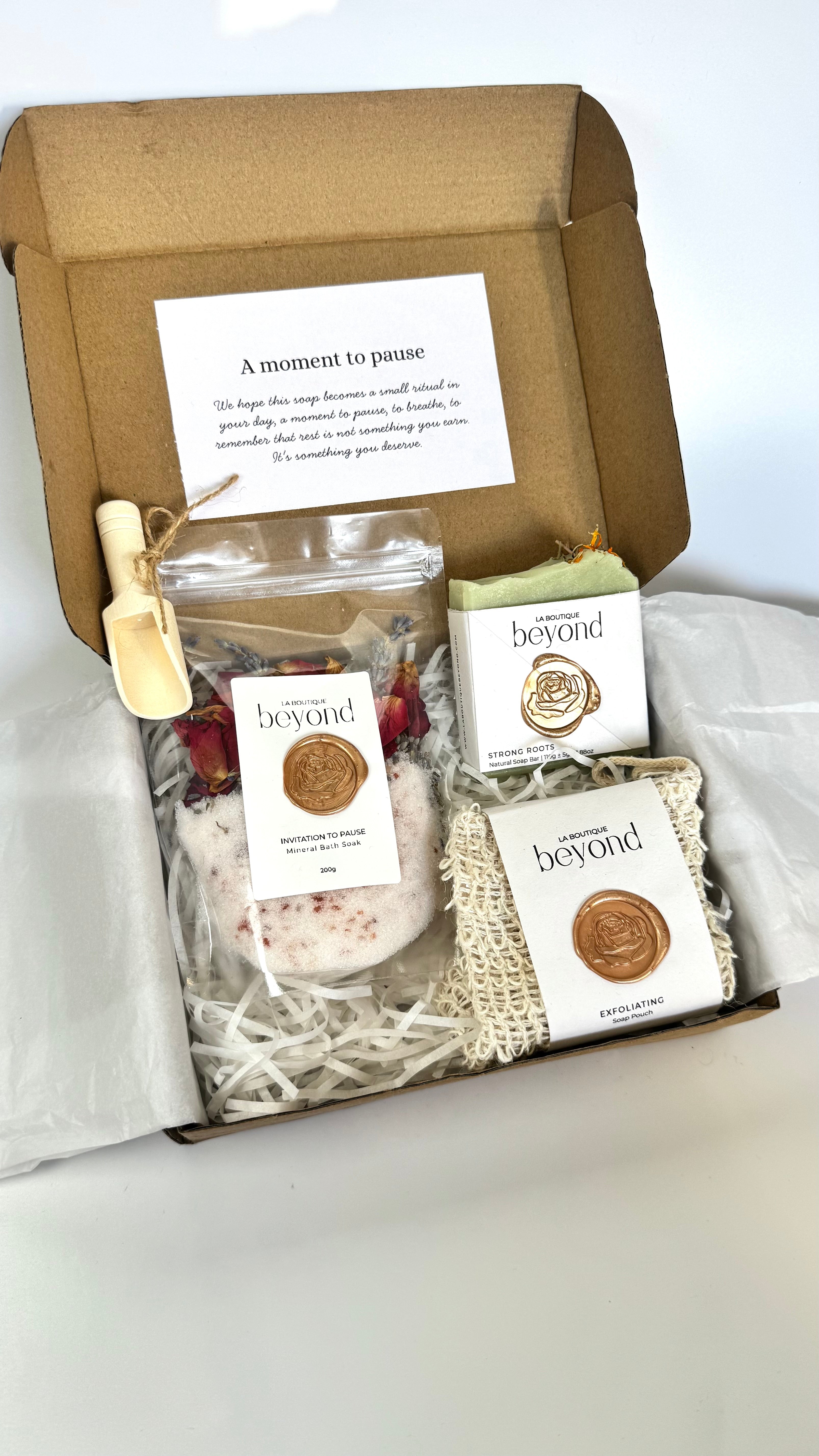 Green rosemary cedarwood soap bar with soap pouch and bath soak to choose from for the gift set box of 'La Boutique Beyond' coffee packages on a light gray background 