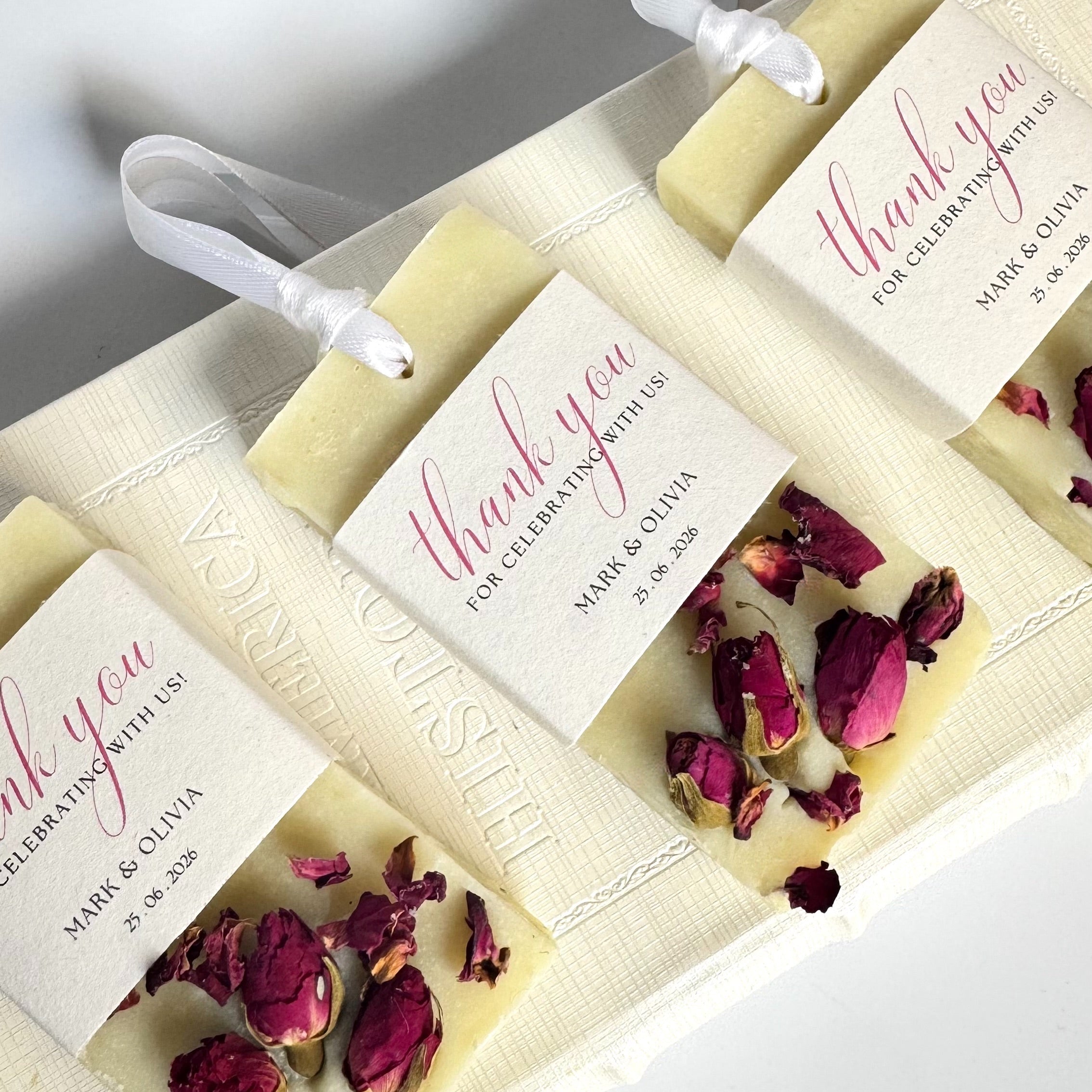 Set of mini soap samples for wedding, celebrations, birthday, bay shower with dried flowers and 'thank you' labels on a white background