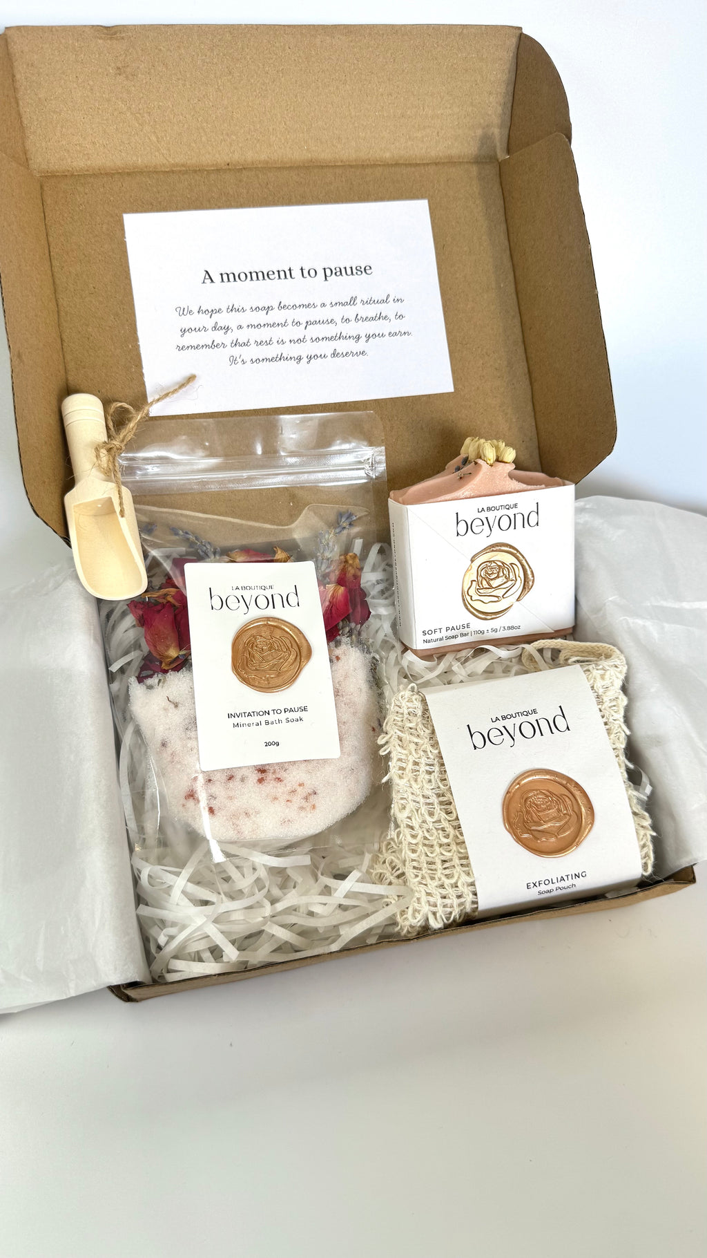 Pink rose geranium chamomile soap bar with soap pouch and bath soak to choose from for the gift set box of 'La Boutique Beyond' coffee packages on a light gray background 