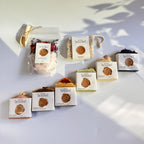 Row of soap bars  with soap pouch and bath soak to choose from for the gift set box of 'La Boutique Beyond' coffee packages on a light gray background