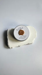 Tin of mini travel soap beads and a packaging box labeled 'La Boutique Beyond' on a light background.