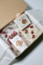 Valentine's Day Gift Soap Set for her, with pink natural soap bars, bath soak, soap pouch with dried fruit and flowers in a box on a white background