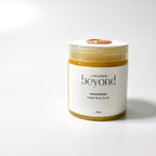 Jar of orange zest sugar body scrub on a white background