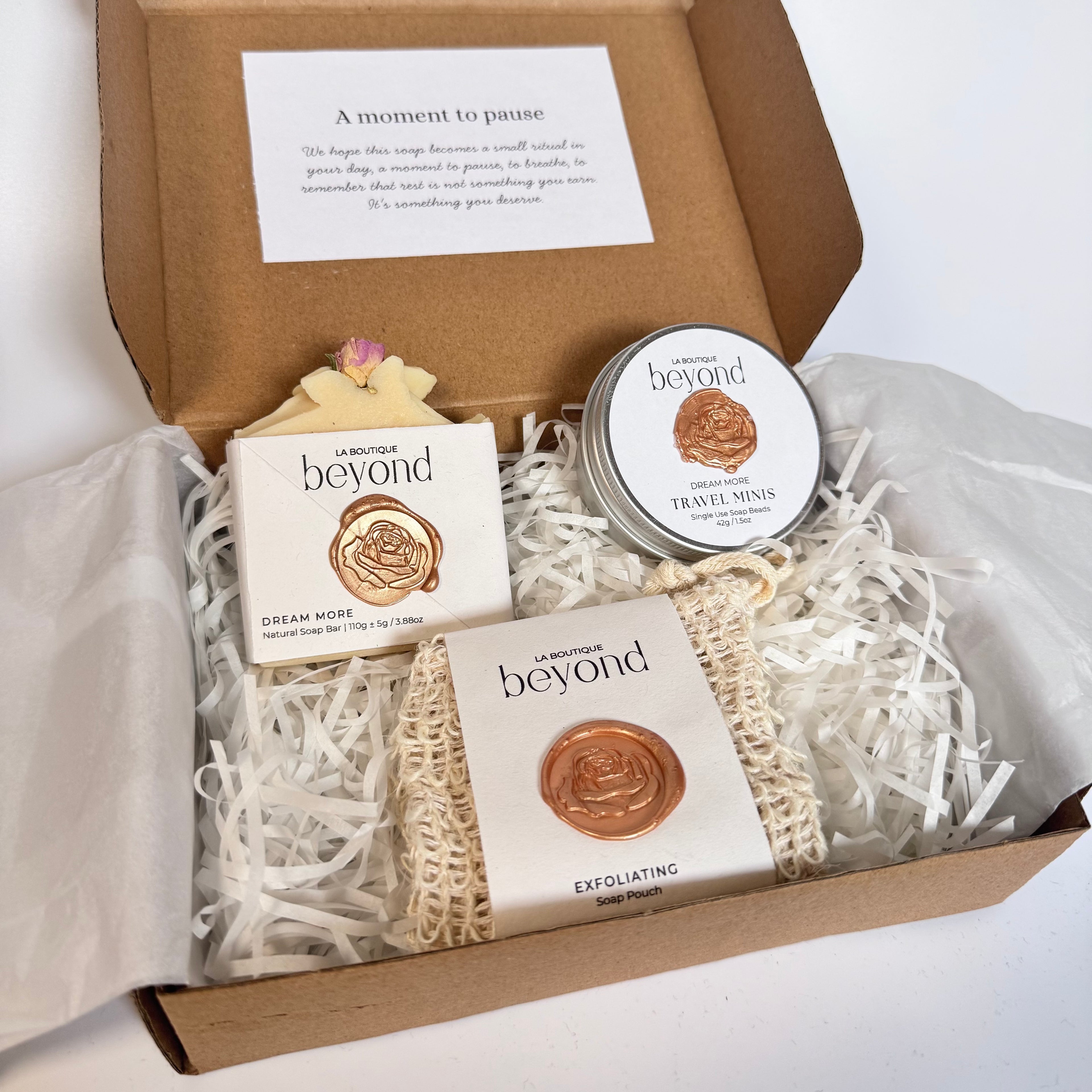 La Boutique Beyond gift set with handmade natural soap, bath soak, Travel Minis, and exfoliating scrub in a gift box with a slow living message card