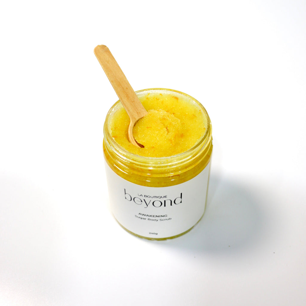 Jar of orange zest sugar body scrub on a white background